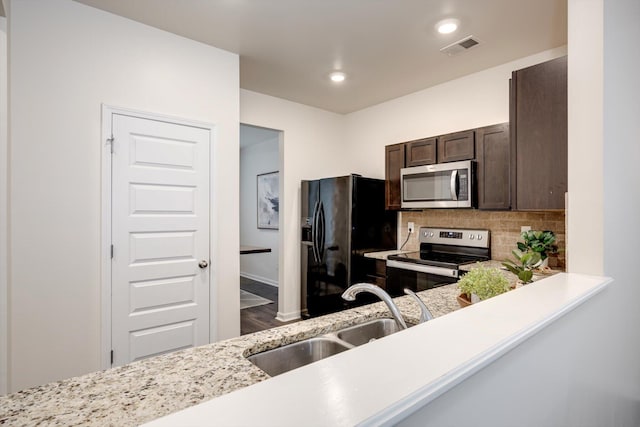 2178 River Park Ct, Augusta, GA 30907 - kitchen featuring appliances with stainless steel finishes, dark brown cabinets, tasteful backsplash, wood finished floors, and recessed lighting