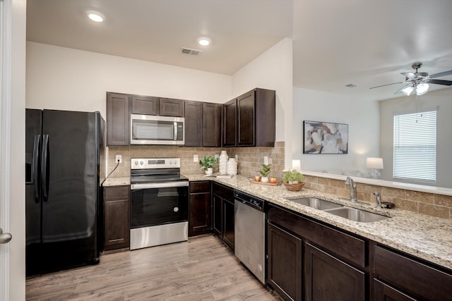 2178 River Park Ct, Augusta, GA 30907 - kitchen featuring stainless steel appliances, dark brown cabinetry, backsplash, light stone countertops, and a ceiling fan