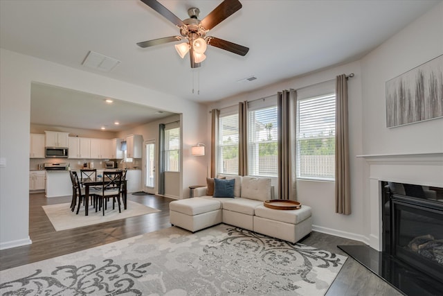 427 Roebuck Pass, Grovetown, GA 30813 - living area with dark wood finished floors, ceiling fan, a glass covered fireplace, recessed lighting, and baseboards