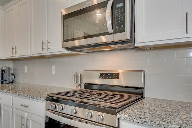 427 Roebuck Pass, Grovetown, GA 30813 - kitchen with stainless steel appliances, decorative backsplash, white cabinetry, and light stone countertops