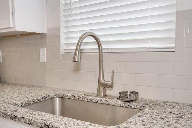 427 Roebuck Pass, Grovetown, GA 30813 - kitchen view of a sink, white cabinetry, decorative backsplash, and light stone counters