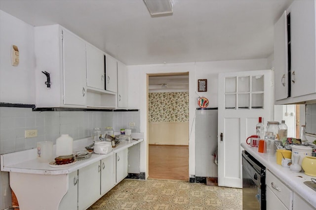 2514 Lumpkin Rd, Augusta, GA 30906 - kitchen featuring black dishwasher, light countertops, white cabinetry, and backsplash