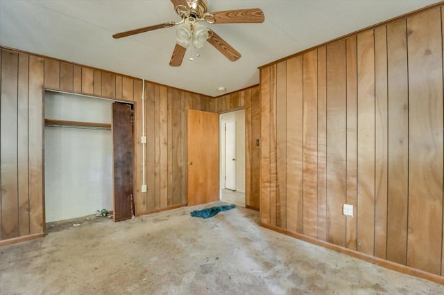2514 Lumpkin Rd, Augusta, GA 30906 - unfurnished bedroom with baseboards, a closet, carpet flooring, wooden walls, and a ceiling fan