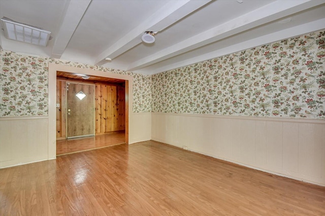 2514 Lumpkin Rd, Augusta, GA 30906 - empty room with beamed ceiling, wallpapered walls, a wainscoted wall, and wood finished floors
