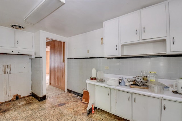 2514 Lumpkin Rd, Augusta, GA 30906 - kitchen featuring white cabinetry, light countertops, open shelves, and visible vents