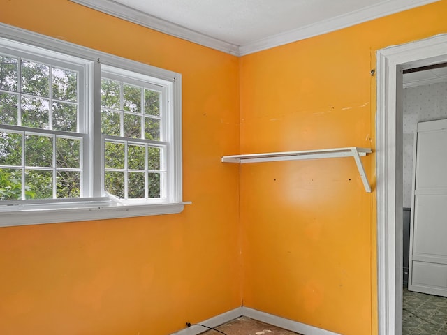 interior space featuring crown molding and stacked washing maching and dryer