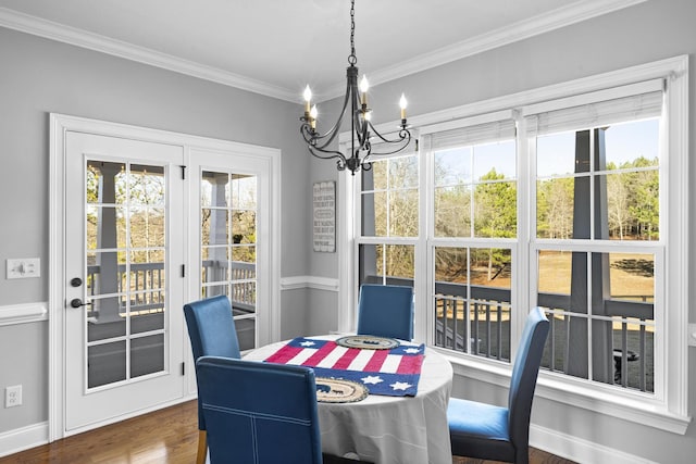 dining space featuring a chandelier, dark wood-style flooring, baseboards, and crown molding