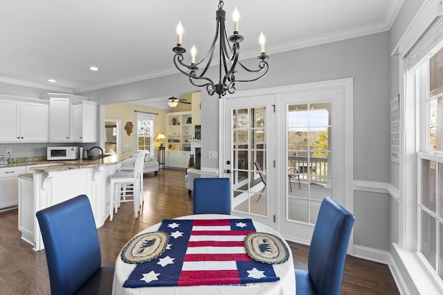 dining space featuring crown molding and dark wood-style flooring