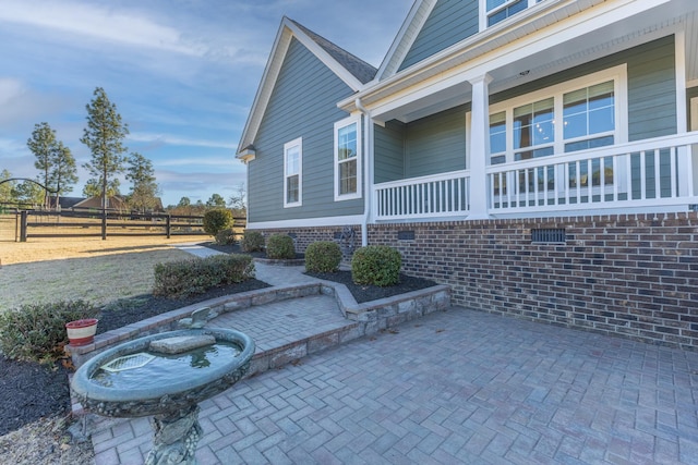 view of side of property with a patio area and fence