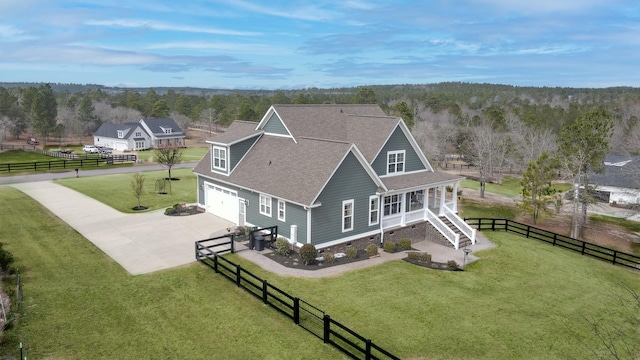 drone / aerial view with a forest view and a rural view