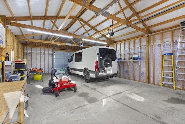 garage featuring metal wall and a garage door opener