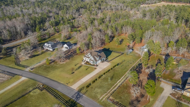 drone / aerial view featuring a wooded view