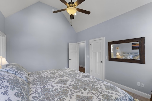 carpeted bedroom featuring high vaulted ceiling, baseboards, and a ceiling fan