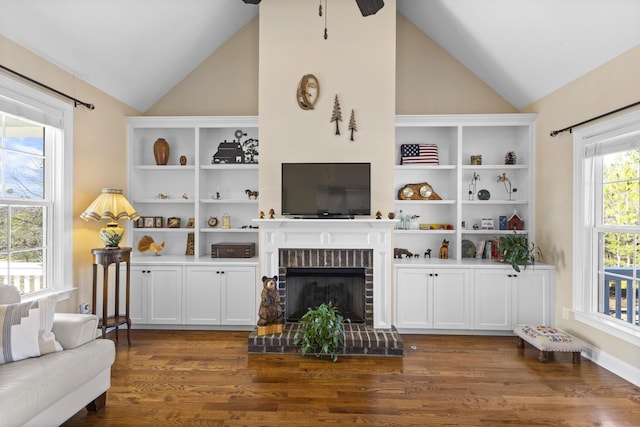 living room featuring dark wood-style floors, ceiling fan, a brick fireplace, and lofted ceiling