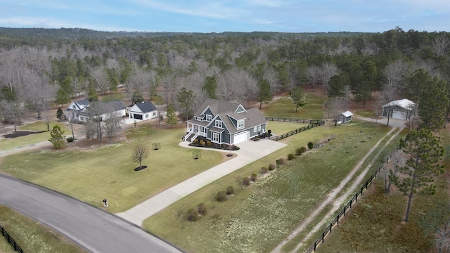 birds eye view of property featuring a view of trees