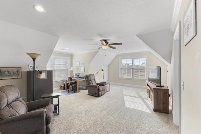 living room with crown molding, lofted ceiling, a ceiling fan, carpet flooring, and baseboards