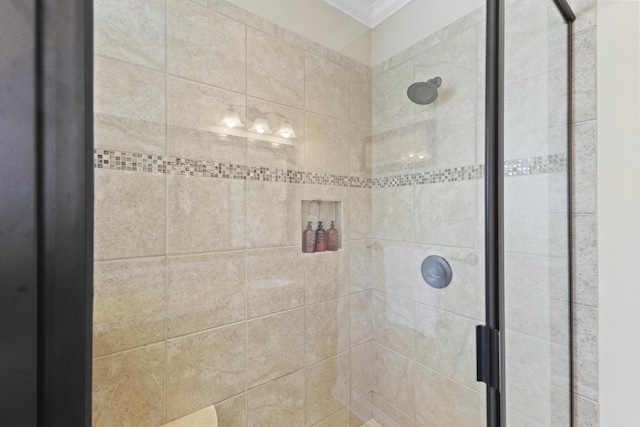 bathroom featuring ornamental molding and a stall shower