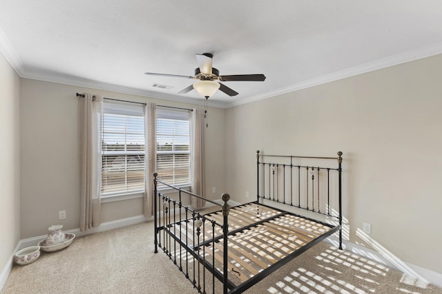 carpeted bedroom featuring visible vents, baseboards, and ornamental molding