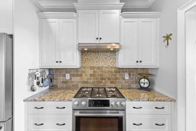 kitchen with stainless steel appliances, white cabinets, under cabinet range hood, and decorative backsplash