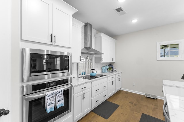 4136 Buffalo Trl, Evans, GA 30809 - kitchen with oven, wall chimney exhaust hood, built in microwave, dark wood finished floors, and white cabinetry