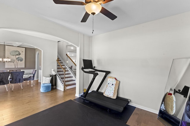 4136 Buffalo Trl, Evans, GA 30809 - workout room featuring arched walkways, wood finished floors, ceiling fan, and a chandelier