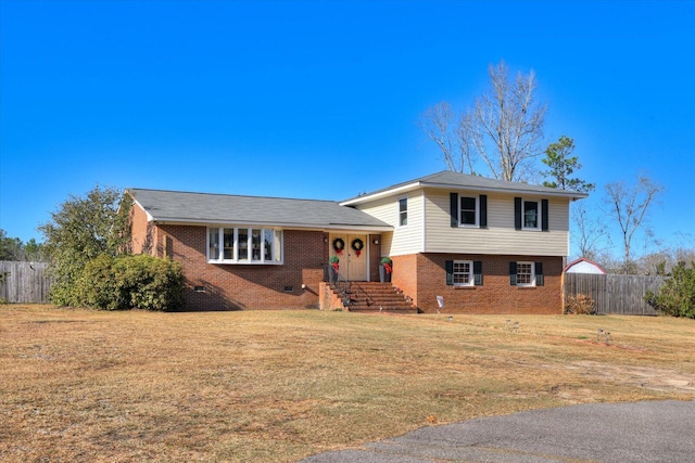 tri-level home with a front lawn