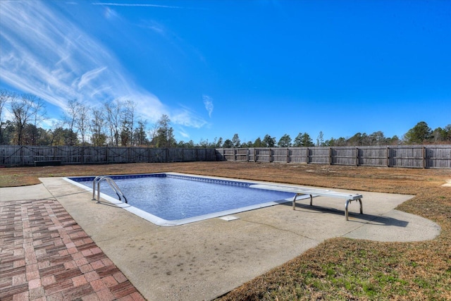 view of pool with a diving board