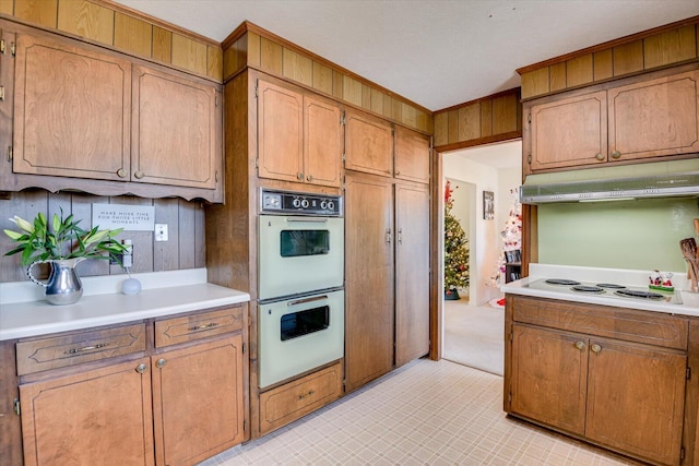 kitchen featuring white appliances and wooden walls