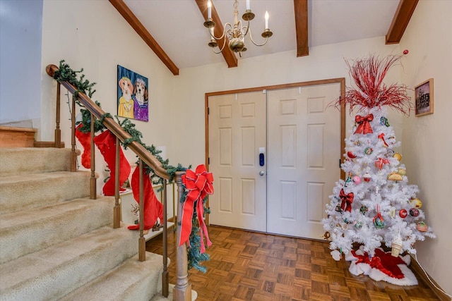 foyer entrance with dark parquet floors, lofted ceiling with beams, and an inviting chandelier