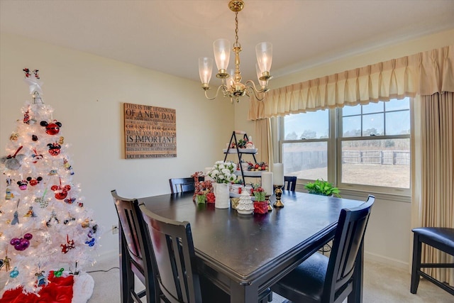 carpeted dining room featuring a notable chandelier