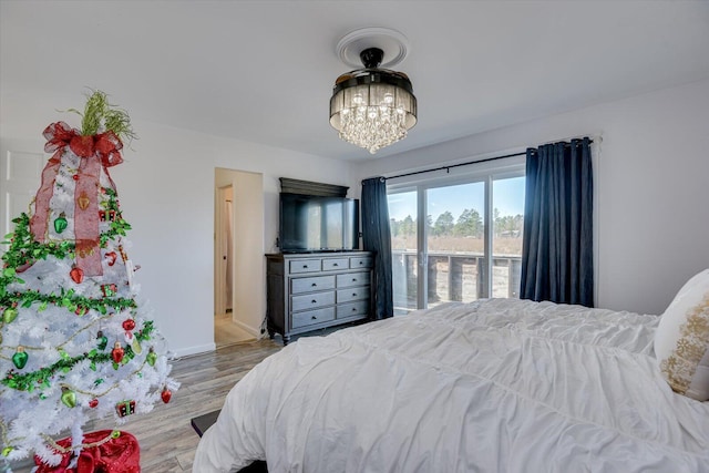 bedroom featuring light hardwood / wood-style floors and a notable chandelier