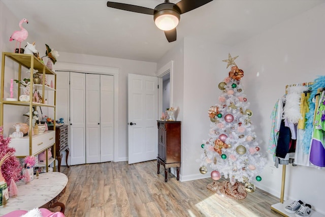 bedroom with light wood-type flooring, a closet, and ceiling fan