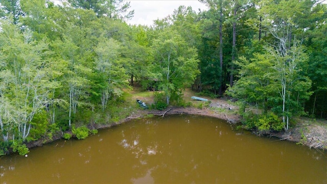 aerial view featuring a water view and a forest view