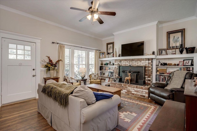 living area featuring ornamental molding, a ceiling fan, a fireplace, and wood finished floors