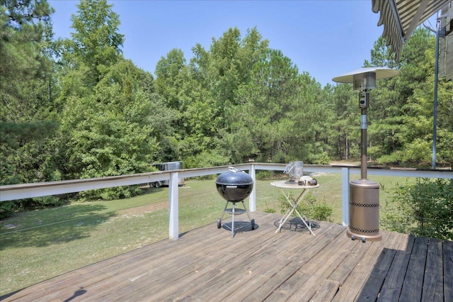 deck featuring a yard and a grill