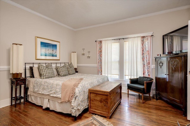 bedroom with ornamental molding, dark wood finished floors, and baseboards