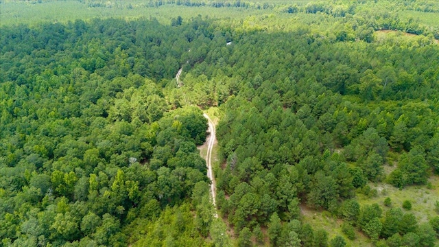 birds eye view of property featuring a view of trees