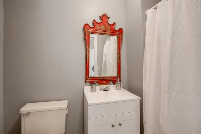 bathroom featuring toilet and vanity