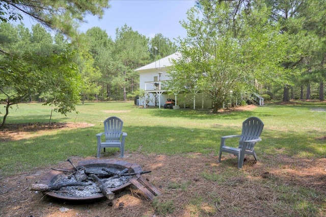 view of yard with a deck, an outdoor fire pit, and stairs