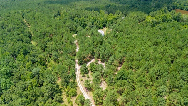 birds eye view of property featuring a wooded view