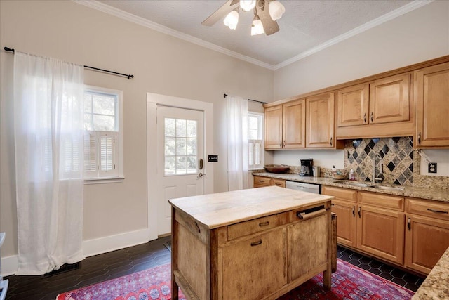 kitchen featuring a sink, a ceiling fan, stainless steel dishwasher, ornamental molding, and decorative backsplash