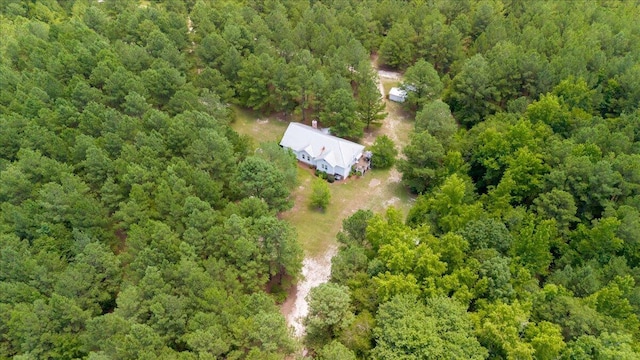 birds eye view of property with a view of trees