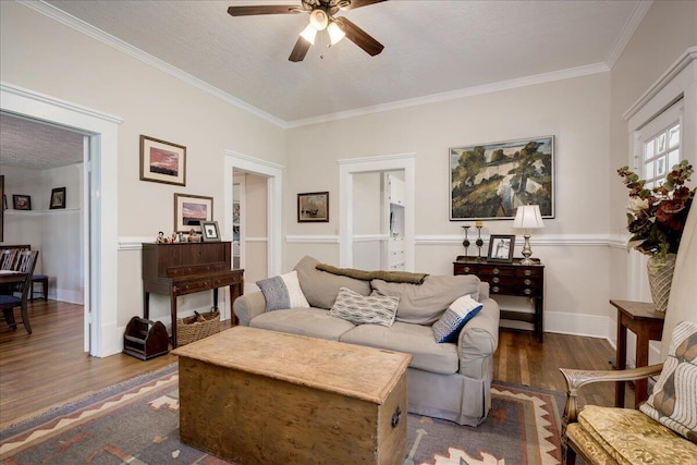 living room with dark wood-style floors, crown molding, a ceiling fan, a textured ceiling, and baseboards