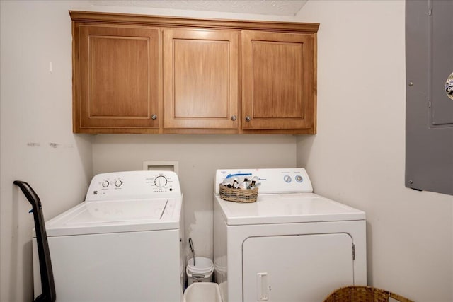 laundry area featuring cabinet space, washing machine and dryer, and electric panel