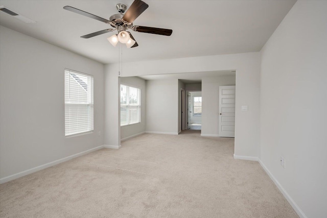 carpeted spare room with ceiling fan