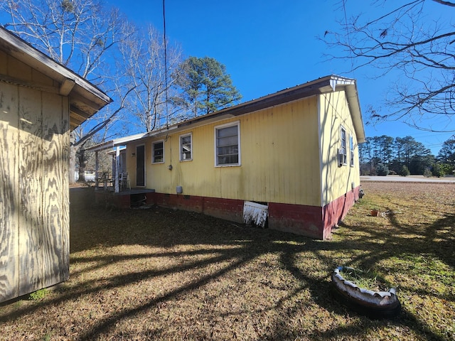 view of side of home featuring a lawn