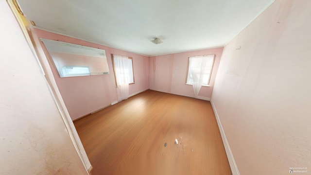 empty room with light hardwood / wood-style flooring