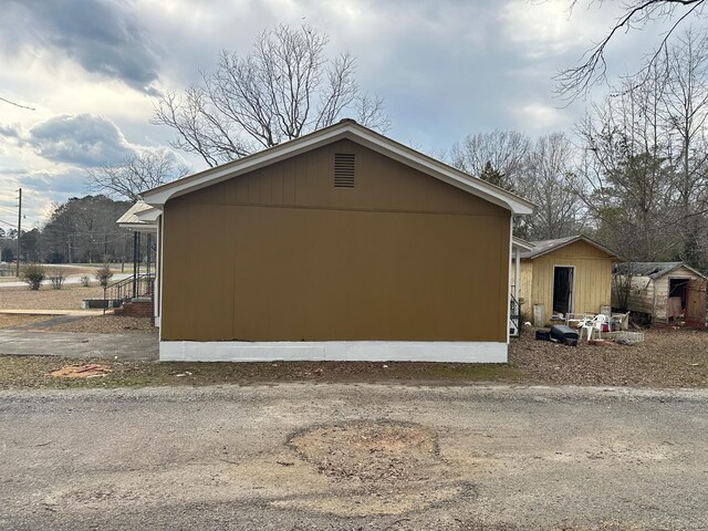 view of home's exterior featuring cooling unit and a carport