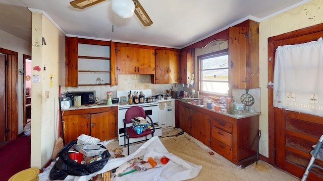 kitchen featuring ceiling fan, crown molding, and white stove