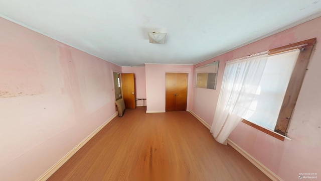 hall with light hardwood / wood-style flooring